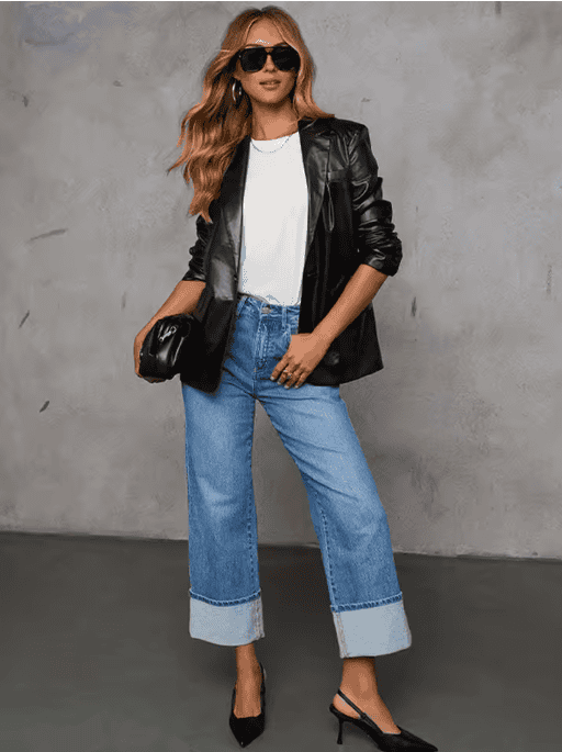 Woman wearing a leather blazer with blue jeans for a casual spring outfit.