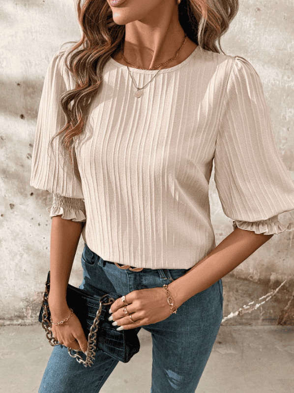 Chic long sleeve blouse styled for spring, paired with denim for a comfortable yet elegant look.