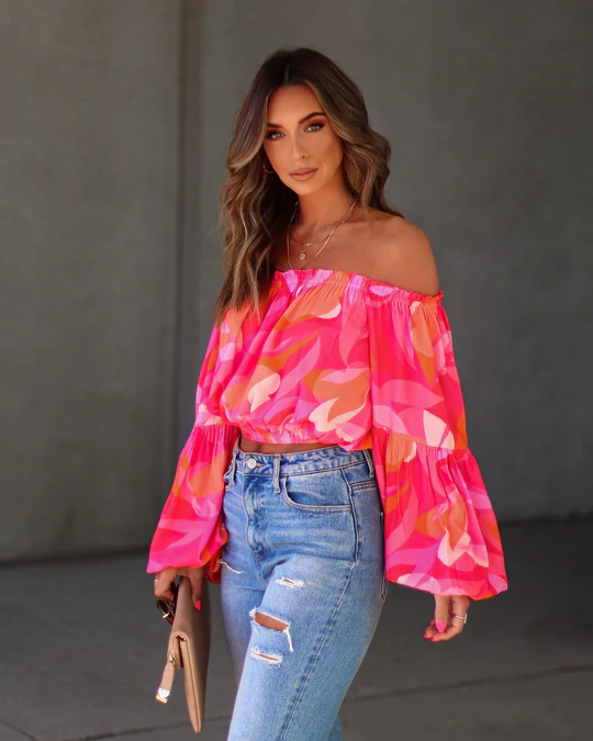 Floral top styled for spring, paired with denim jeans for a fresh, vibrant look.