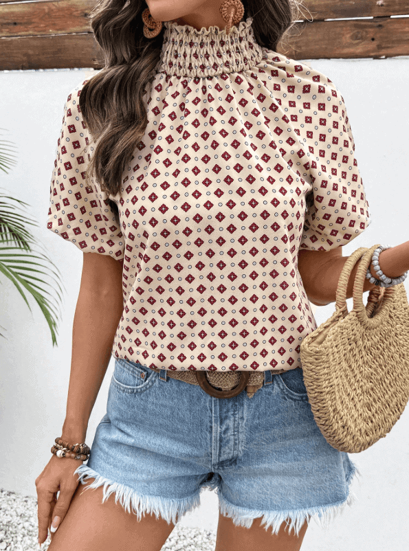 Woman wearing a sleeveless high neck blouse styled for summer.