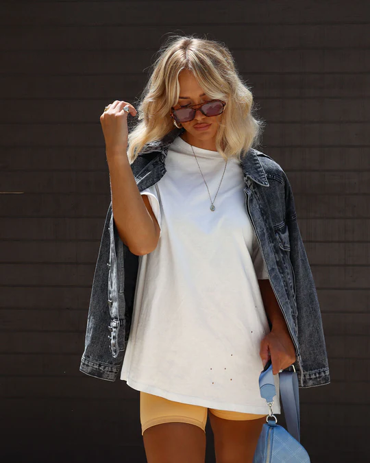 Stylish summer outfit for summer capsule wardrobe 2025 featuring denim shorts, a slim jacket, and a classic white T-shirt.