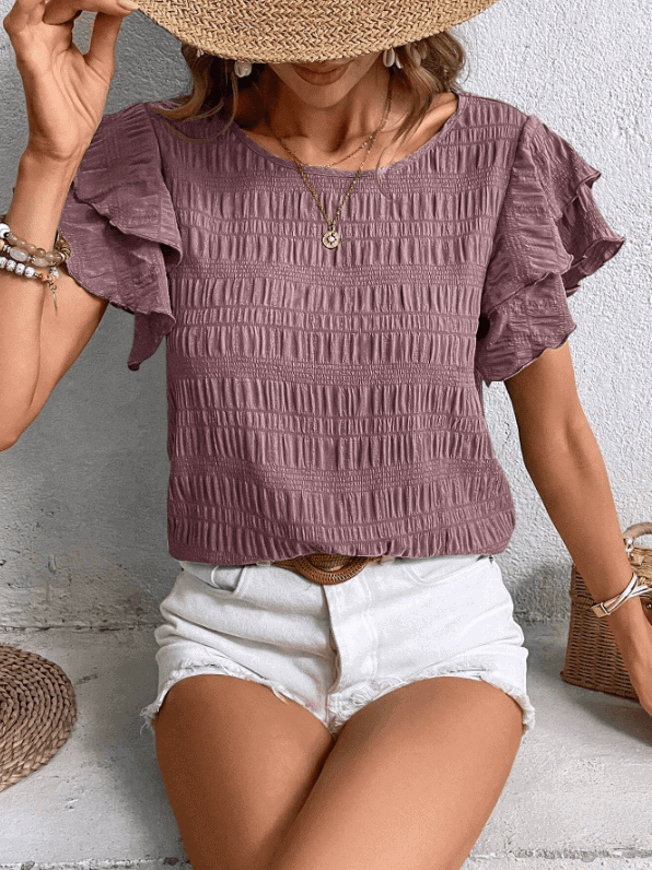 Woman in a wide neckline, straight cut top designed to flatter a pear-shaped body.